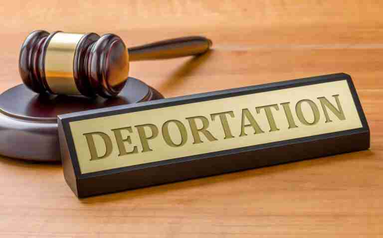 A gavel and sign that says deportation.